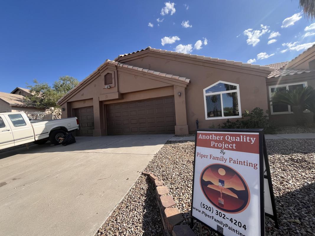 A freshly painted Tucson home under a clear and bright sky.
